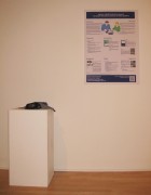 Photography showing poster on wall and prototype on pillar